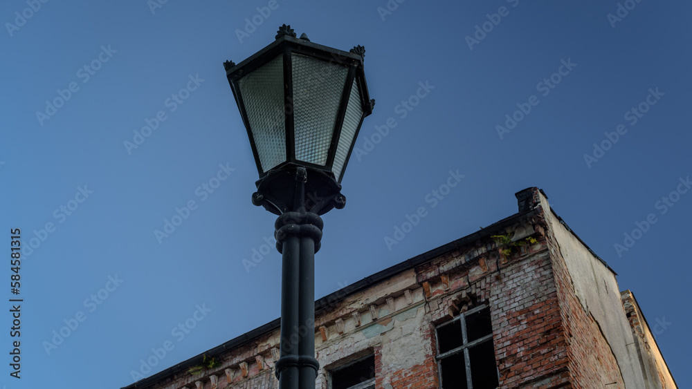 STREET LANTERN - City landscape with an old building in the background STREET LANTERN - City landscape with an old building in the background