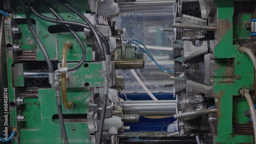 Injection molding machine for plastic products during operation. Technology for the production of plastic products from polypropylene.