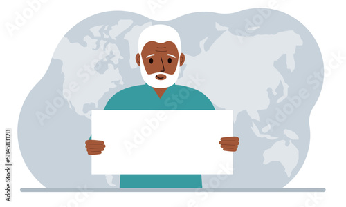 The concept of world attention. A man holds a white poster in his hands against the background of a world map.