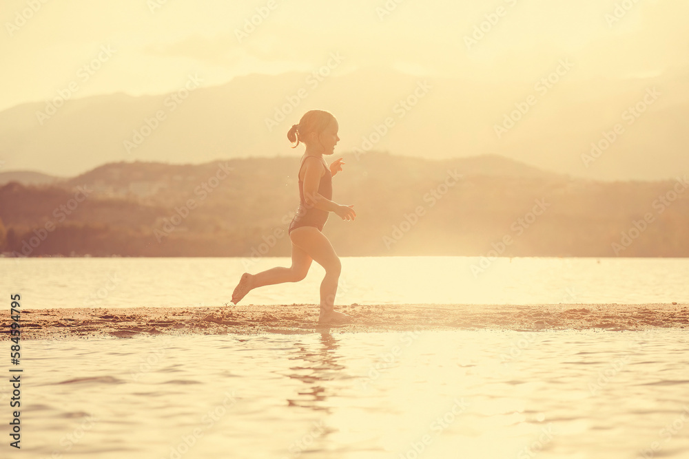 little girl at the seaside running on the beach