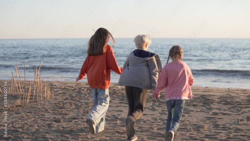 Children holding hands running to the sea, Turkey, Alanya Children holding hands running to the sea, Turkey, Alanya