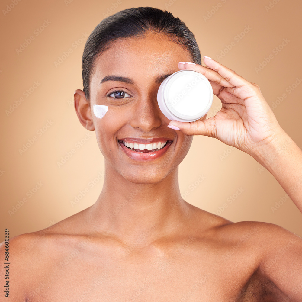 Indian woman, skincare cream and jar in portrait with smile, happiness and wellness by brown background. Happy model, lotion product and face in studio for dermatology, aesthetic and cosmetic beauty Indian woman, skincare cream and jar in portrait with smile, happiness and wellness by brown background. Happy model, lotion product and face in studio for dermatology, aesthetic and cosmetic beauty