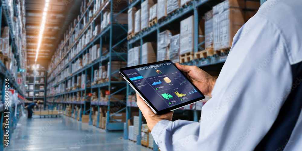 Smart Warehouse,Inventory management system concept.Manager using digital tablet,showing warehouse software management dashboard on blurred warehouse as background - obrazy, fototapety, plakaty 