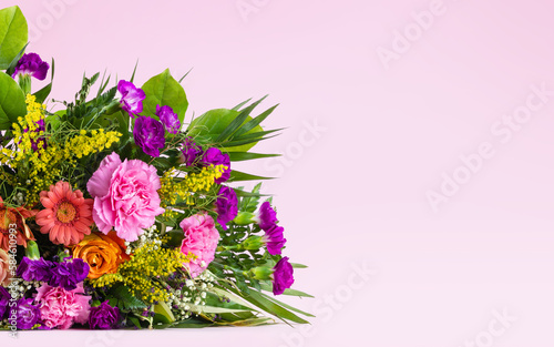 bouquet of colorful flowers on a pink background for presentation of data  product display  ads or graphic design composition with space for text. Floral composition.