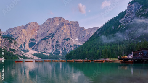 Lago di Braies Braies lake, Pragser wildsee at sunrise. Trentino Alto Adidge, Dolomites mountains, South Tyrol, Italy, Europe. Boats in the morning at the lake photo