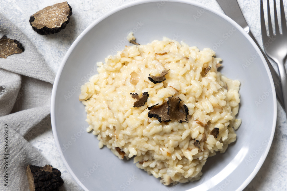 Risotto with porcini mushrooms and black truffles served in a plate top view, gourmet cousine Risotto with porcini mushrooms and black truffles served in a plate top view, gourmet cousine