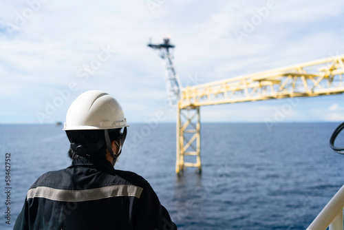 The bridge extends to release gas or a burning flame on an offshore platform. © MR.Zanis