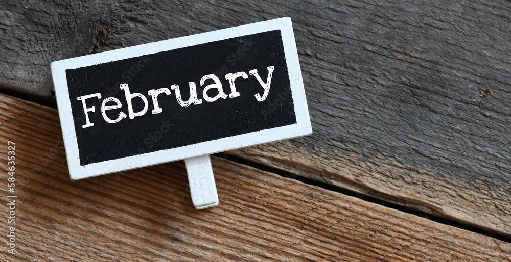 Naklejka premium February on chalk board and table.