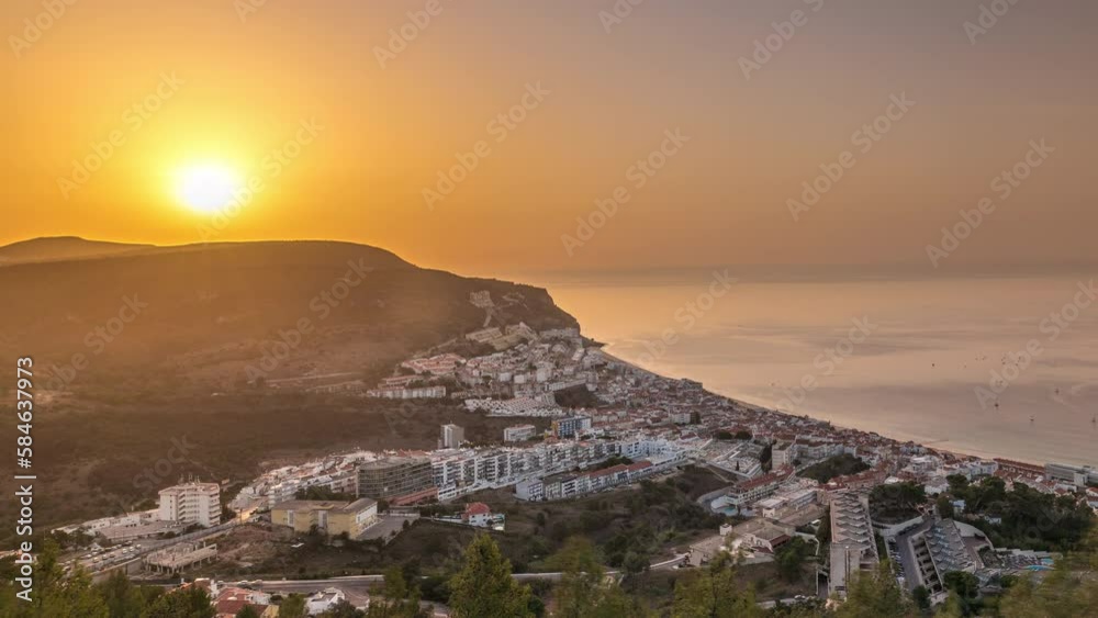 Aerial sunrise view of the coastline of the village of Sesimbra timelapse, in the middle of the Atlantic Ocean. Morning panorama with typical houses from the Castle viewpoint. Portugal Aerial sunrise view of the coastline of the village of Sesimbra timelapse, in the middle of the Atlantic Ocean. Morning panorama with typical houses from the Castle viewpoint. Portugal