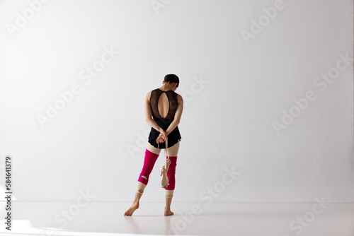 Back view. Graceful classical dance training over white background. Beauty and grace. Copy space for ad © Lustre