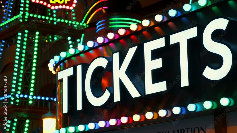 Video Stock Tickets sign lights up the night at the amusement park ...