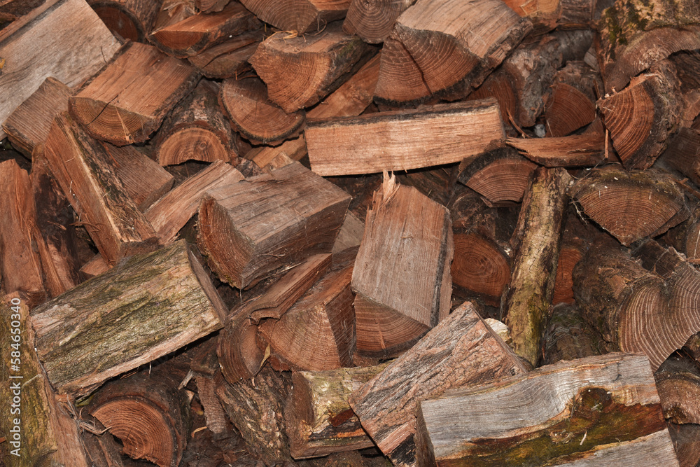Logs, natural wood texture background. Pile of chopped firewood tree logs at lumber mill. Preparation for winter time. Fireplace or stove material. Timber industry concept. Close up, selective focus Logs, natural wood texture background. Pile of chopped firewood tree logs at lumber mill. Preparation for winter time. Fireplace or stove material. Timber industry concept. Close up, selective focus