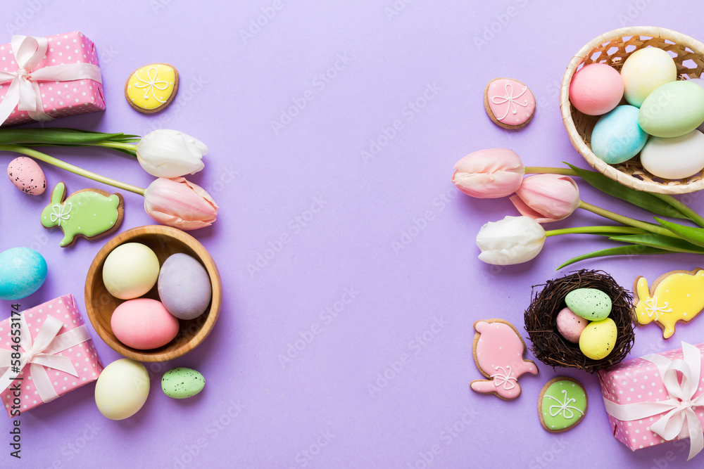 Easter frame with eggs, gift box and tulip on a colored background. The minimal concept. Top view Happy Easter composition. Card with a copy space of the place for the text Easter frame with eggs, gift box and tulip on a colored background. The minimal concept. Top view Happy Easter composition. Card with a copy space of the place for the text