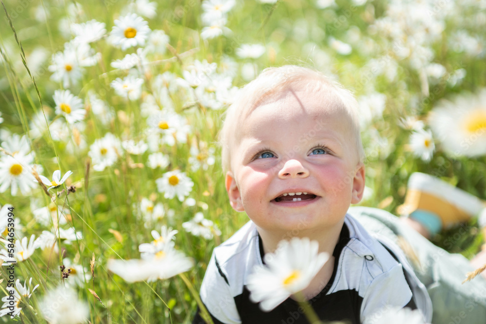 one year old laughing boy lying on his stomach in a meadow full of daisies in the Czech Republic, wearing yellow shoes and enjoying a warm spring sunny day
one year old laughing boy lying on his stomach in a meadow full of daisies in the Czech Republic, wearing yellow shoes and enjoying a warm spring sunny day