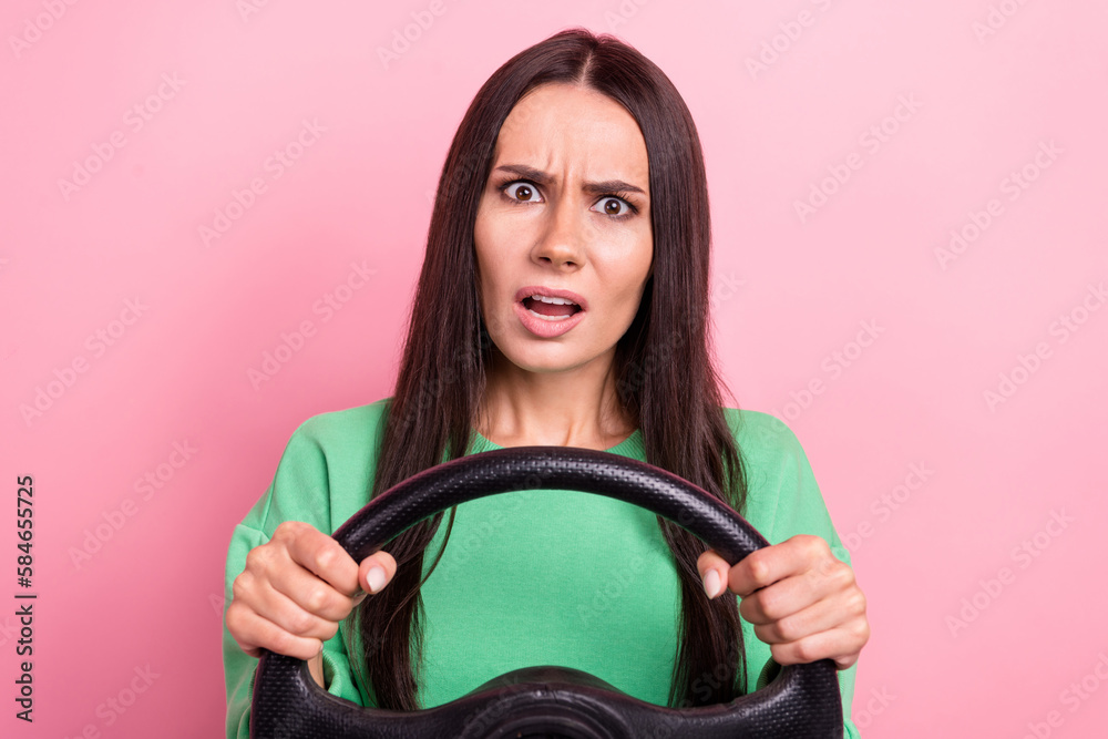 Photo of unhappy young latin car driver lady hold steering wheel green jumper dissatisfied car traffic long range isolated on pink color background - obrazy, fototapety, plakaty 