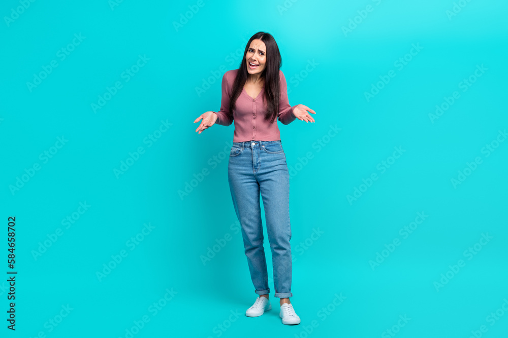 Full body length photo of unhappy mad woman wear stylish shirt denim jeans shrug shoulders bad mood furious isolated on aquamarine color background - obrazy, fototapety, plakaty 
