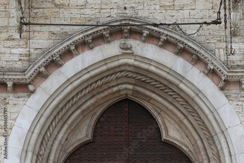 Palazzo dei Priori Exterior Detail with Sculpted Arch in Perugia  Umbria  Italy