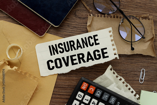 insurance coverage text on torn paper on the background of different stationery photo