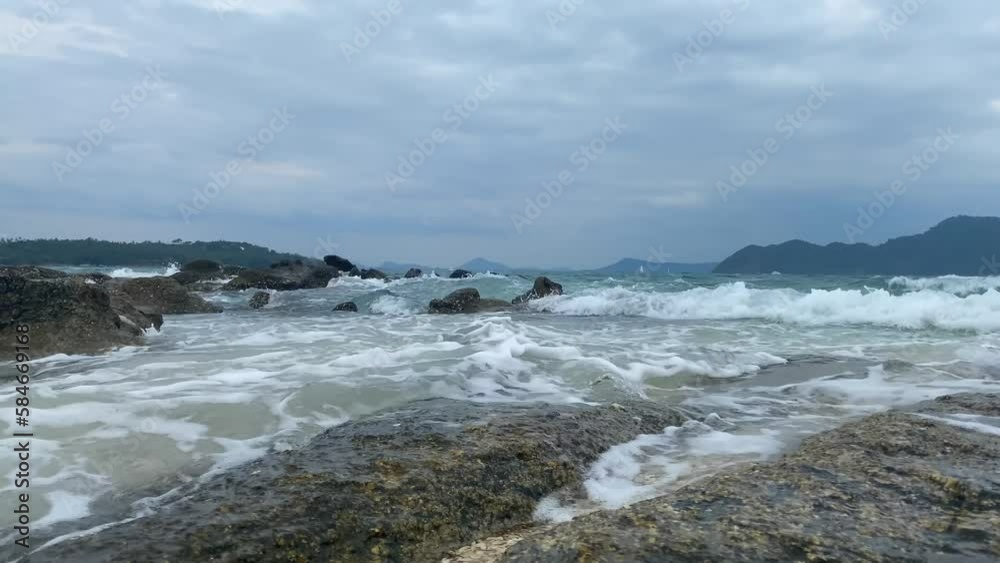 Small waves turn into foam on the shore. Small waves turn into foam on the shore.