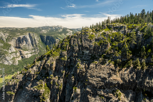 Yosemite Falls In The Distance Behind Sheer Rock Wall At Taft Point