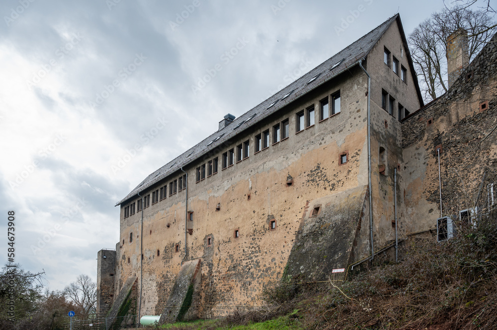 Old high building with windows on top at Ronneburg Castle, Germany during cloudy day, wide angle shot