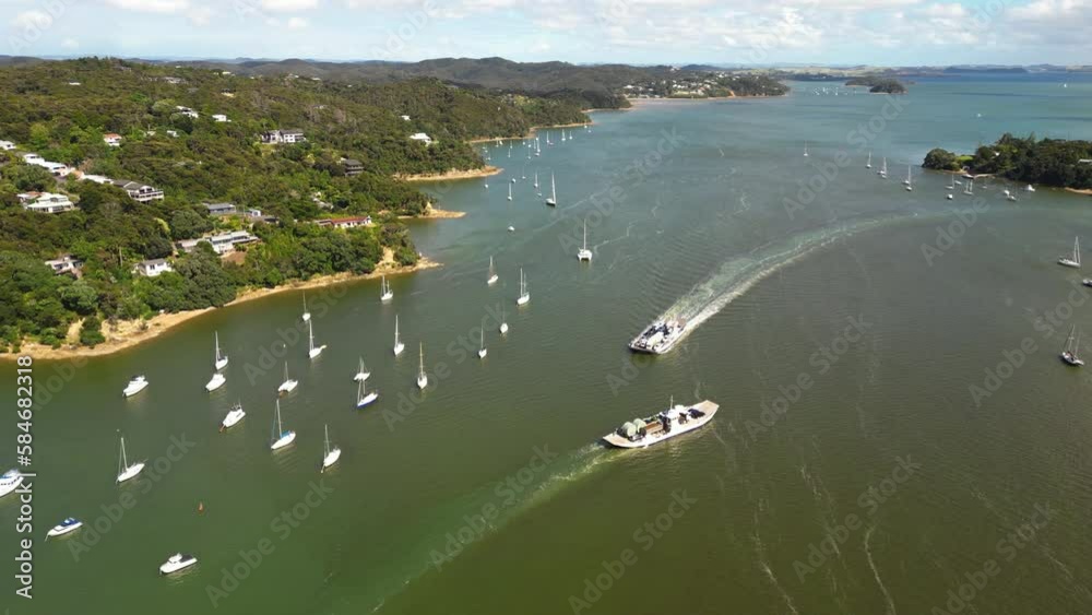 Aerial view over Bay of Islands with anchored sailboats and departing ferry Aerial view over Bay of Islands with anchored sailboats and departing ferry