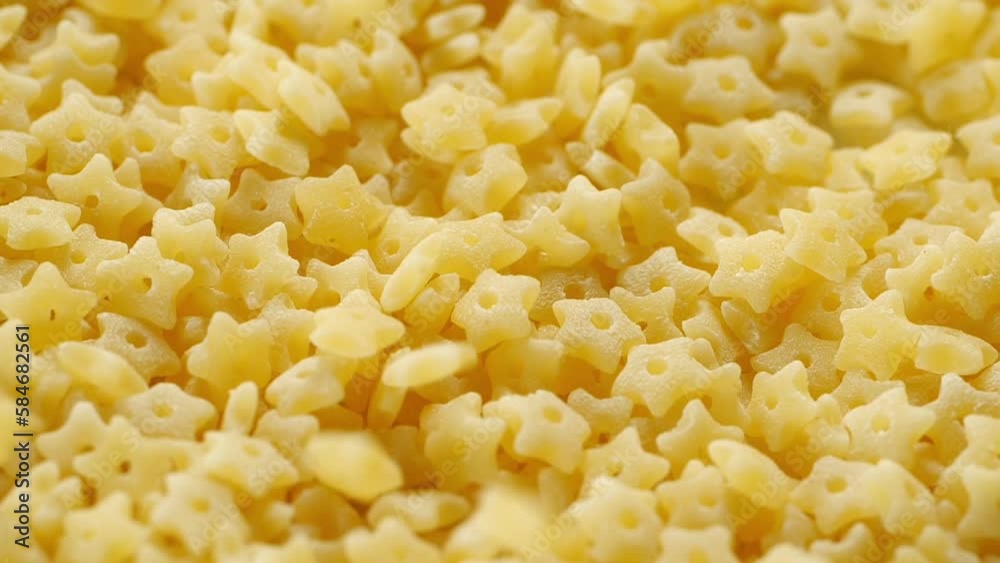 Uncooked Italian Stelline pasta, macro shot close up. Uncooked Italian Stelline pasta, macro shot close up.