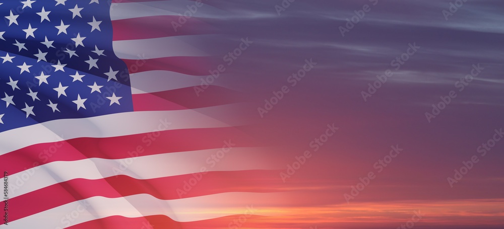 Obraz premium United States of America flag on sky at sunset or sunrise background.