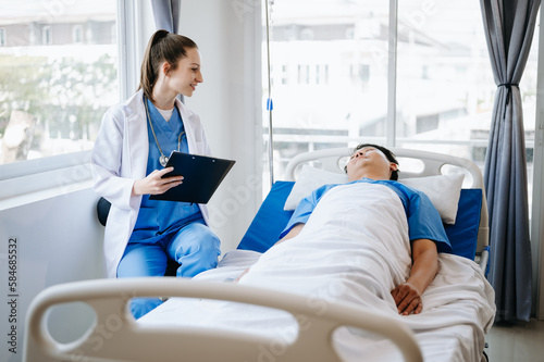  Caucasian doctor smiling take care of a young patient in hospital. Friendly nurse or therapeutic treat client Professional medical service concept.