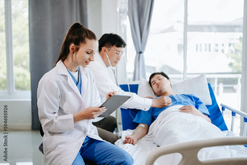 Two doctors talking to a patient lying in his bed  with receiving saline solution in hospital .