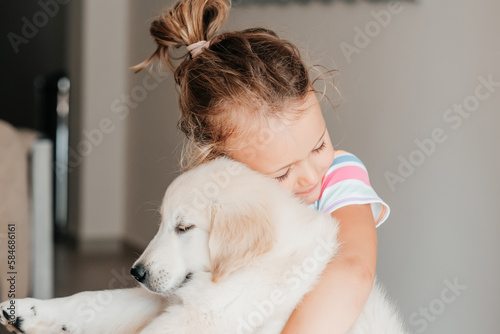child girl play hugging dog puppy golden retriever, pet therapy and canisterapy for adults and children. animal canis assisted therapy. kids emotion mental health friends love tightly cuddle