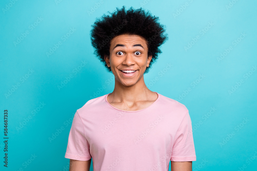 Portrait of surprised funny grimace man smiling wear pink t-shirt interesting chevelure after hairdresser stylist isolated on blue color background Portrait of surprised funny grimace man smiling wear pink t-shirt interesting chevelure after hairdresser stylist isolated on blue color background