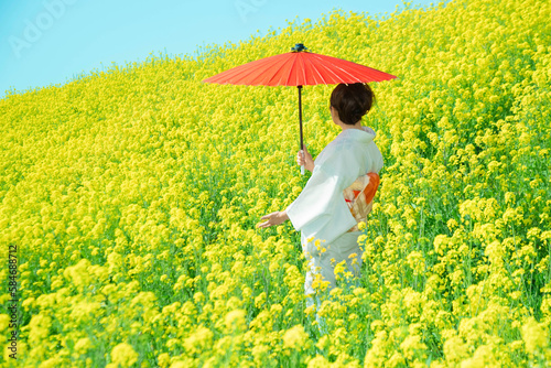 Japanese woman in a beautiful yellow flowers field