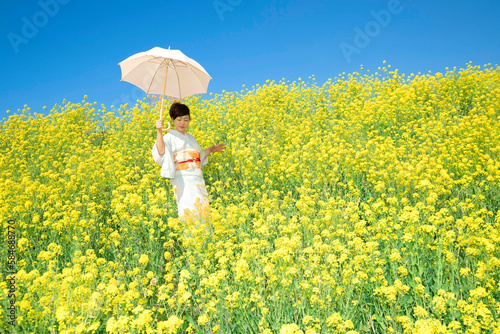 Japanese woman in a beautiful yellow flowers field