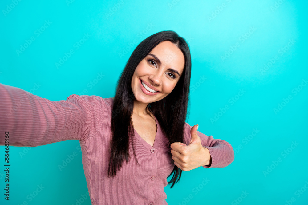 Fototapeta premium Portrait of positive pretty woman pastel clothes making selfie showing thumb up nice job isolated on shine turquoise color background