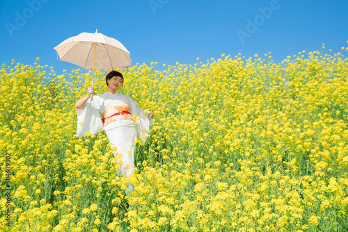 Japanese woman in a beautiful yellow flowers field