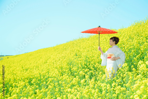 Japanese woman in a beautiful yellow flowers field