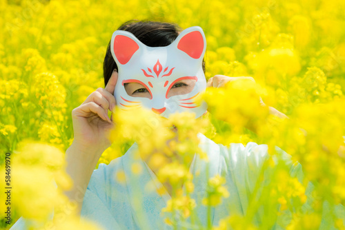 Japanese woman in a beautiful yellow flowers field