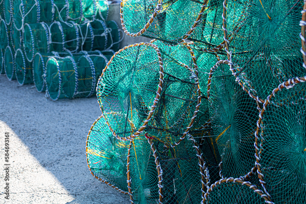 Fishing baskets, fishing pots are placed in a large pile in the port
