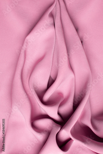 Pink soft fabric shaped as female genital organs, vulva and labia, vagina concept photo