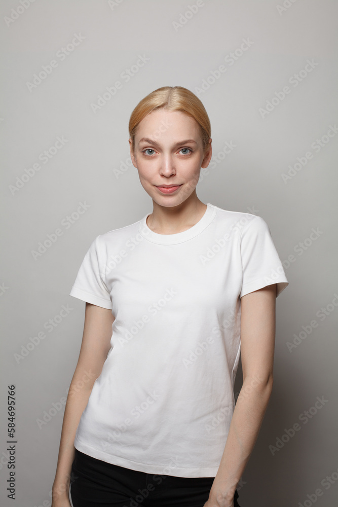 Portrait of young blonde woman in white empty t-shirt posing Portrait of young blonde woman in white empty t-shirt posing