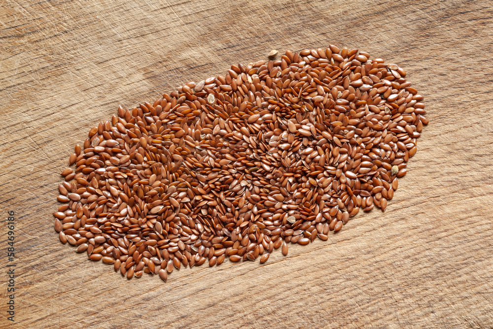 Flax seeds. A bunch of flax seeds on a wooden board. Omega 3. Healthy food Flax seeds. A bunch of flax seeds on a wooden board. Omega 3. Healthy food