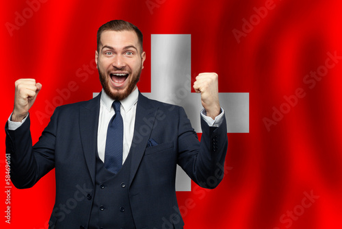 Swiss happy businessman on the background of flag of Switzerland Business, education, degree and citizenship concept photo