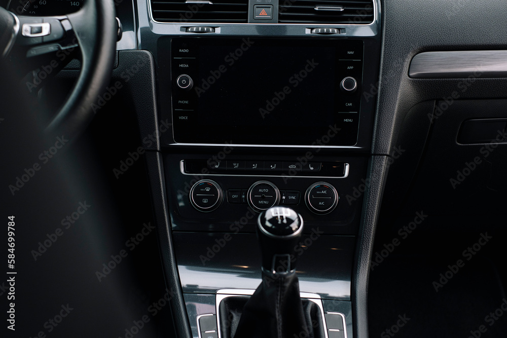 Modern car interior, control details, aluminum, leather steering wheel, Alcantara, car multimedia shown in the car interior. Modern car interior, control details, aluminum, leather steering wheel, Alcantara, car multimedia shown in the car interior.