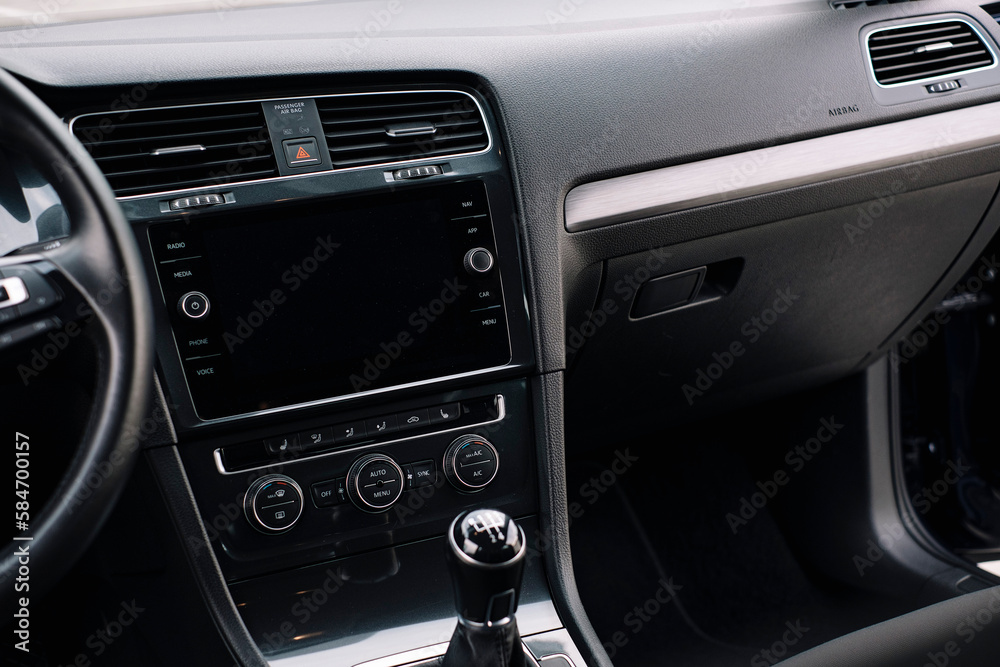Modern car interior, control details, aluminum, leather steering wheel, Alcantara, car multimedia shown in the car interior.