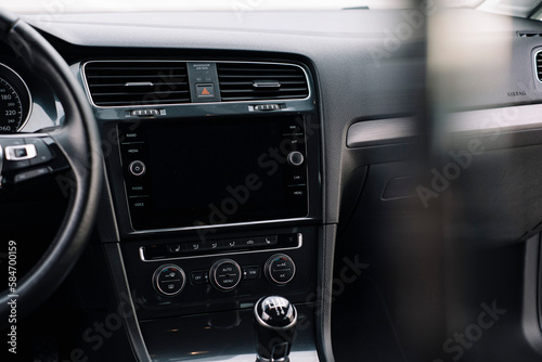 Modern car interior, control details, aluminum, leather steering wheel, Alcantara, car multimedia shown in the car interior. © ARTUR