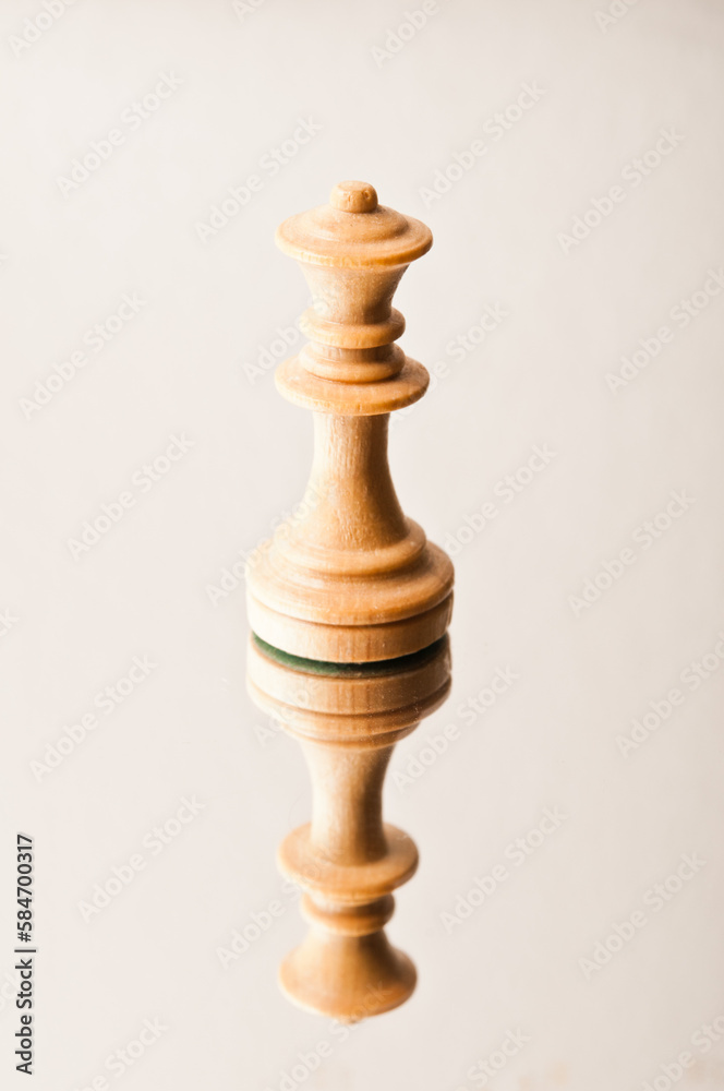 chess piece of Queen on a reflective surface chess piece of Queen on a reflective surface