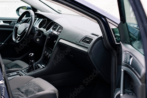 Modern car interior, control details, aluminum, leather steering wheel, Alcantara, car multimedia shown in the car interior.