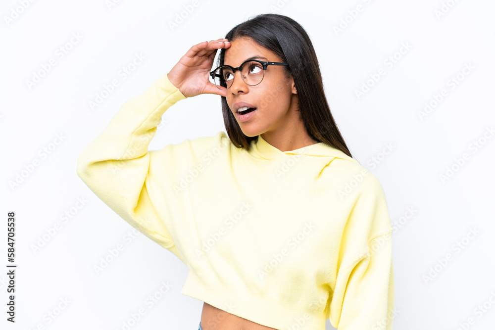 Young African american woman isolated on white background doing surprise gesture while looking to the side Young African american woman isolated on white background doing surprise gesture while looking to the side