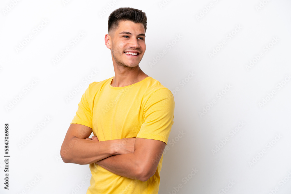 Young caucasian man isolated on white background with arms crossed and happy Young caucasian man isolated on white background with arms crossed and happy